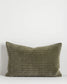 Quilted olive green pillow on a white background