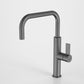 Modern kitchen faucet with a metallic finish on a light gray background