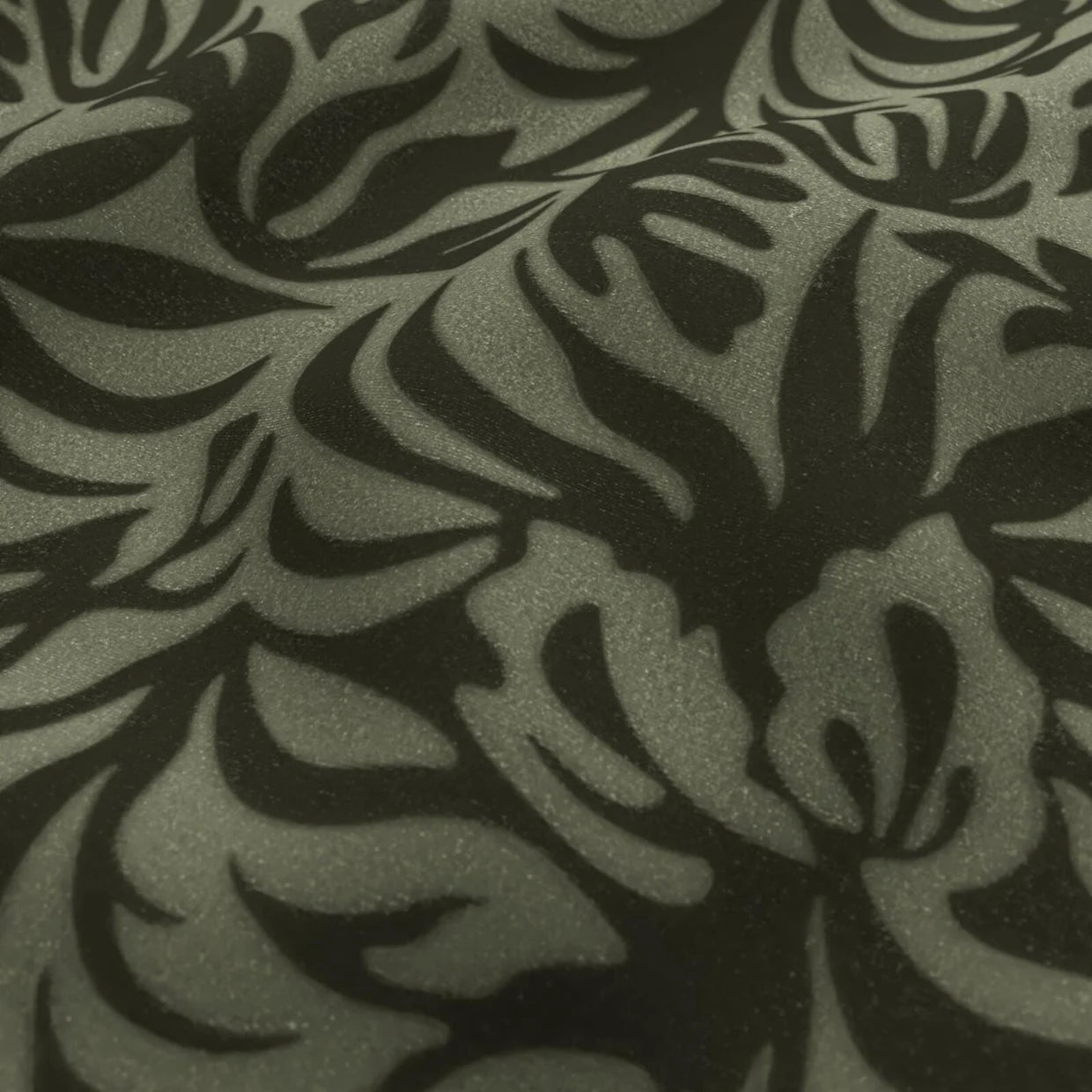 Close-up of a textured fabric with black leaf pattern on gray background