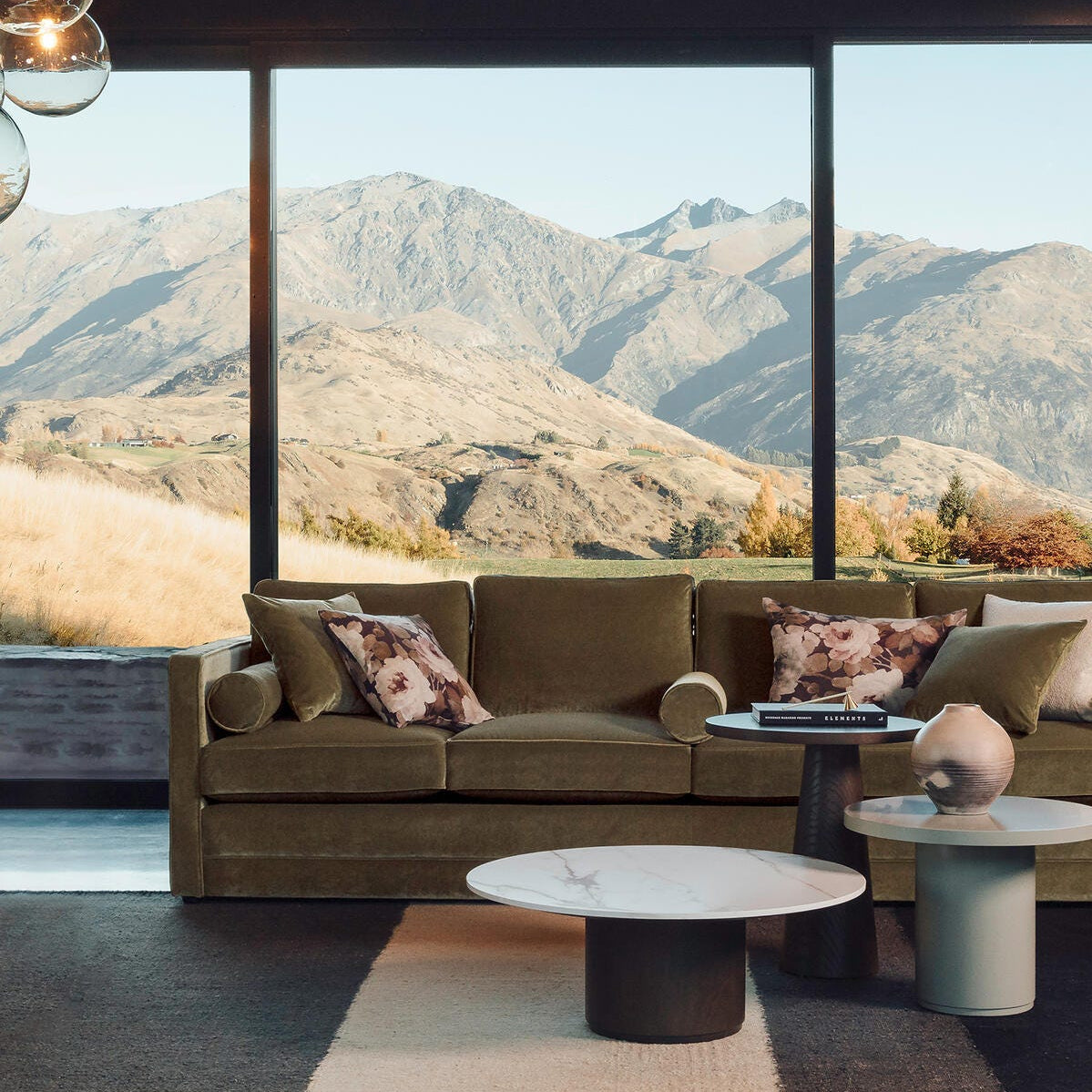 Modern living room with a view of mountains through large windows