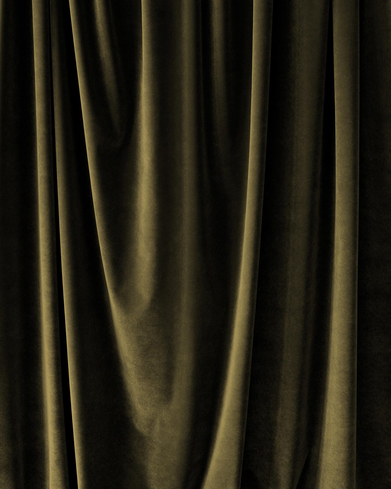 Close-up of dark green velvet fabric with folds