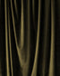 Close-up of dark green velvet fabric with folds