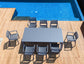 Outdoor dining table with chairs on a wooden deck by a pool