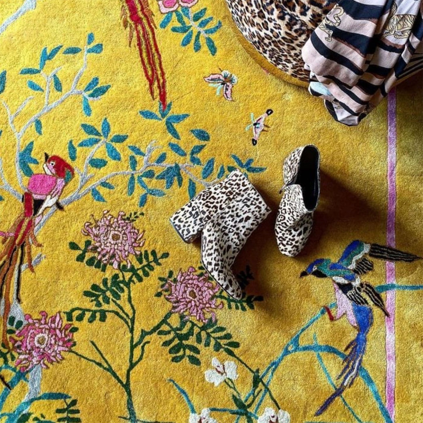 Wendy Morrison Birdsong yellow rug with a close up of animal print ankle boots lying on the rug