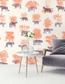Living room with a wall featuring a pattern of leopards and plants, a table with a vase and plant, and a gray sofa.
