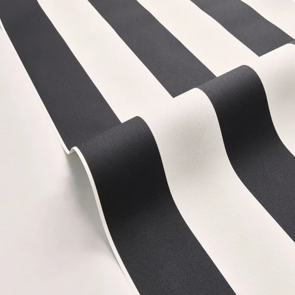 Black and white striped wallpaper shown in a close-up, rolled view to display its texture and pattern.
