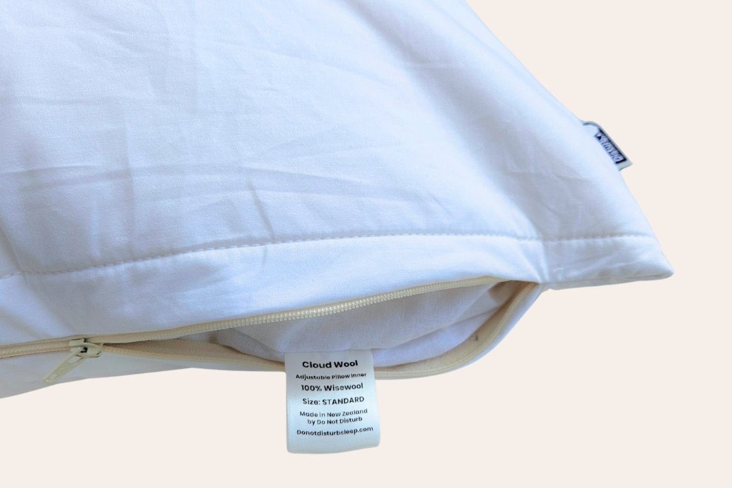 White pillow unzipped showing a wise wool cloud wool label