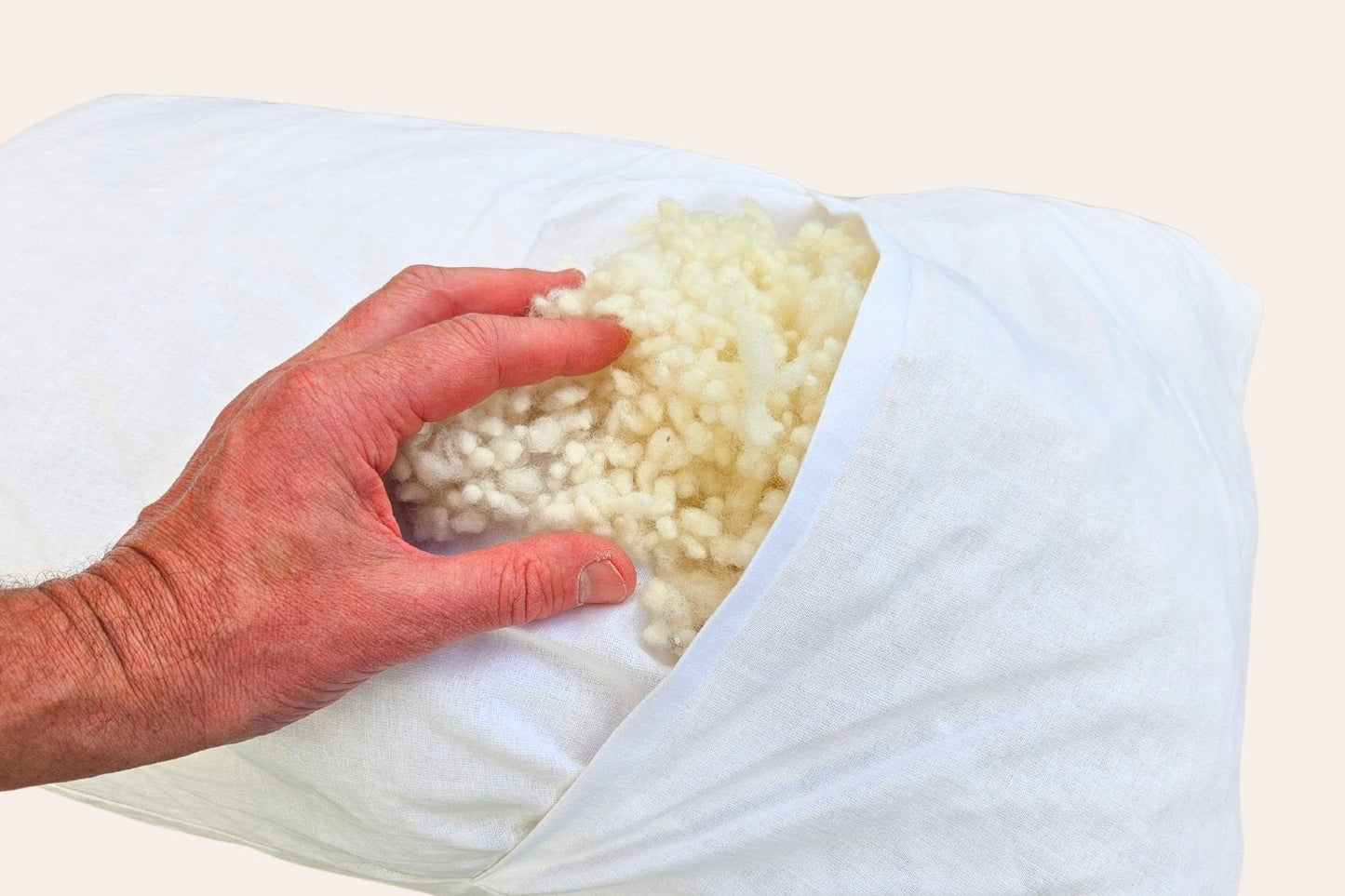hand holding the inner wool of a pillow
