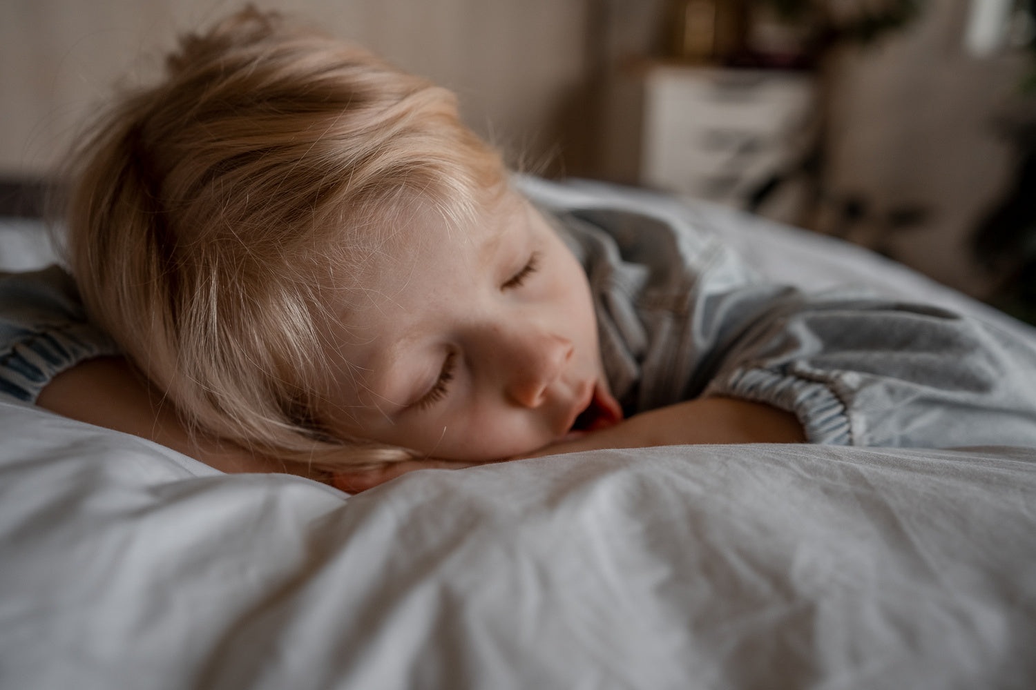 Blonde child yawning in bed