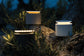 Three solar-powered outdoor lights on a forest floor