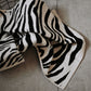 Zebra patterned blanket on a concrete floor