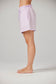 Person wearing light purple shorts on a plain background