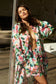Woman wearing a floral robe in a sunlit room