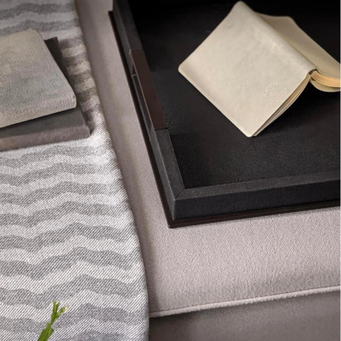 Close-up of a textured surface with a book and decorative items.