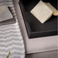 Close-up of a textured surface with a book and decorative items.