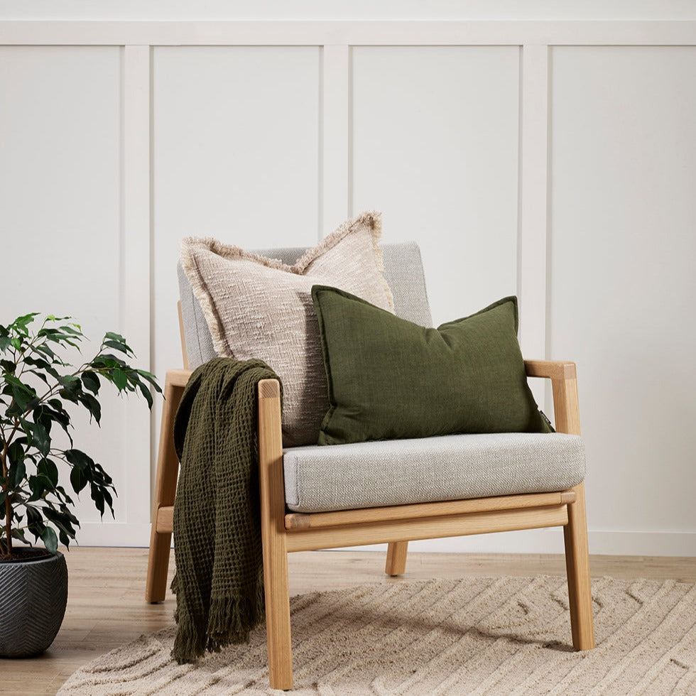 arezzo cushion with khaki cushion on a grey mid century style chair