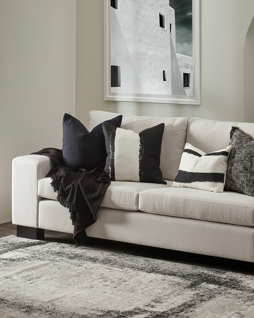 White sofa with decorative pillows in a living room setting