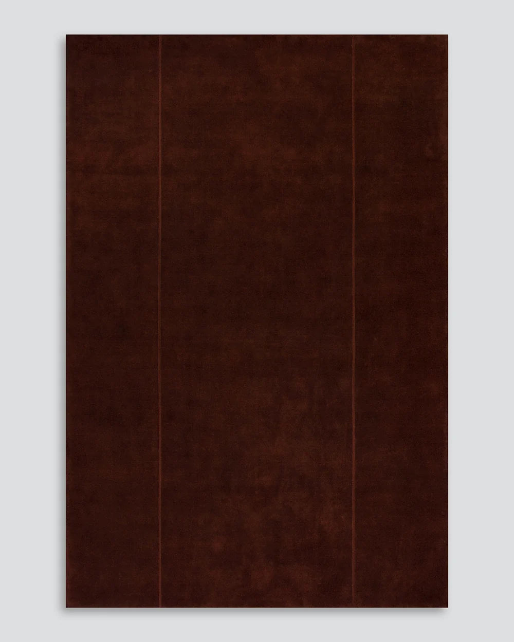 Deep red wine colour Bastion wool rug with a hand stitched vertical line