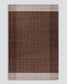 A rectangular woven rug with a textured, cross-hatched pattern in shades of brown and beige, featuring a solid dark brown center and striped borders in beige and brown, shown against a light gray background.
