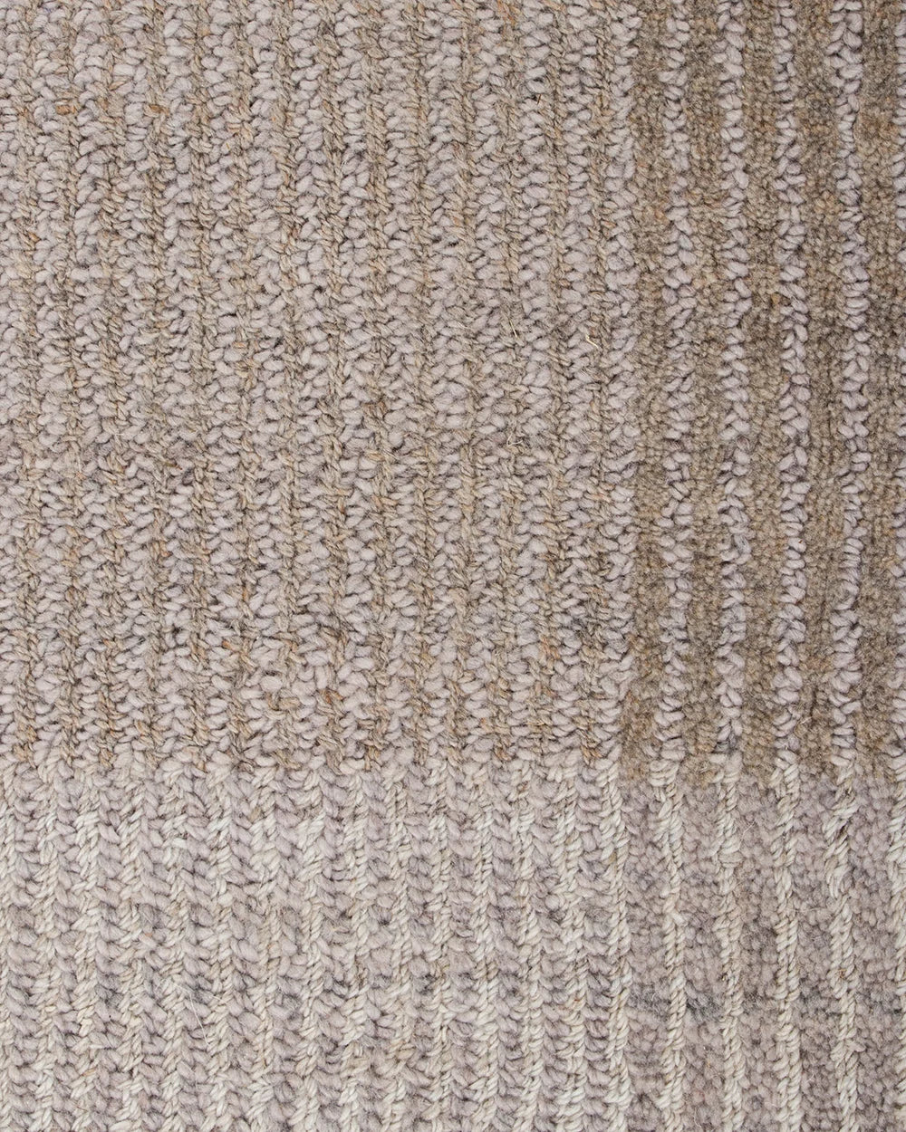 Close-up of a textured knit fabric in a heathered beige and light gray colorway, showing the detailed ribbed stitch pattern.