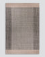 A rectangular woven area rug with a textured central field in warm taupe-gray, bordered by two vertical bands of dark charcoal gray and a light beige border at the top and bottom, shown flat against a neutral light gray background.