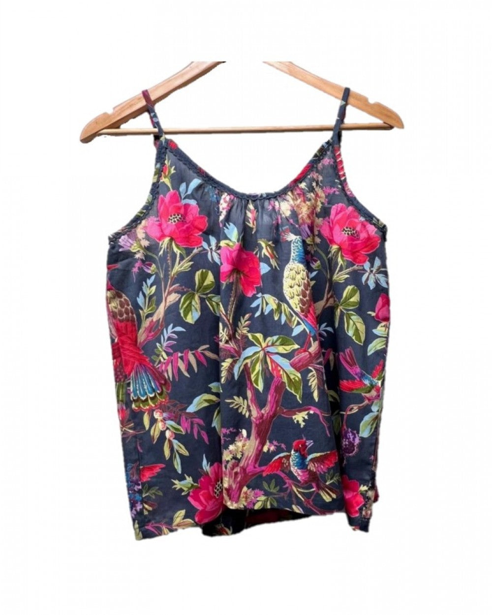 camisole top on a hanger with a vibrant pink blue and green bird and foliage patter on a dark blue background