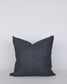 Dark gray pillow on a light gray background