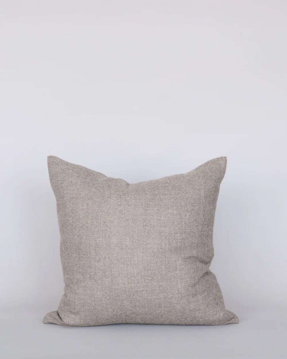Beige pillow on a white background
