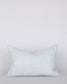Light blue patterned pillow on a light gray background