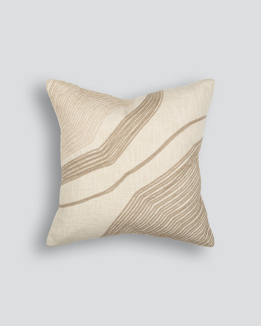 Beige pillow with wavy brown lines on a light gray background