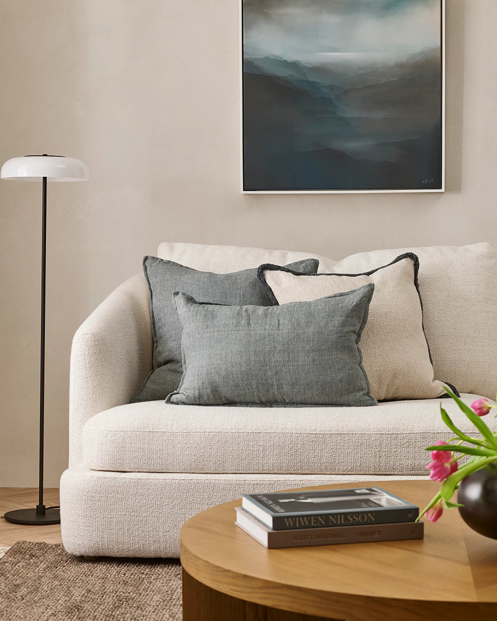 Living room with a beige sofa, coffee table, and decorative elements.
