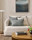 Living room with a beige sofa, coffee table, and decorative elements.