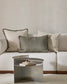 White sofa with decorative pillows and a metallic coffee table in a living room setting.