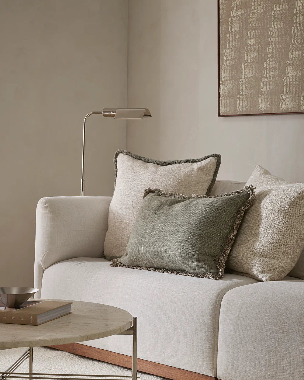 Beige sofa with decorative pillows in a living room setting
