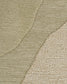 Close-up of a textured area rug with a modern abstract design, featuring three distinct woven patterns in shades of beige and light taupe.