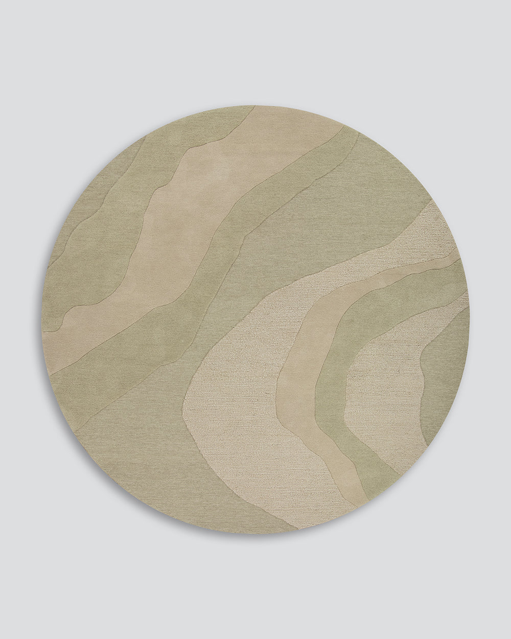 A round area rug with an abstract, layered topographic pattern in muted sage green and beige tones, shown against a neutral light gray background.