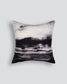 Decorative pillow with black and white abstract design on a light gray background