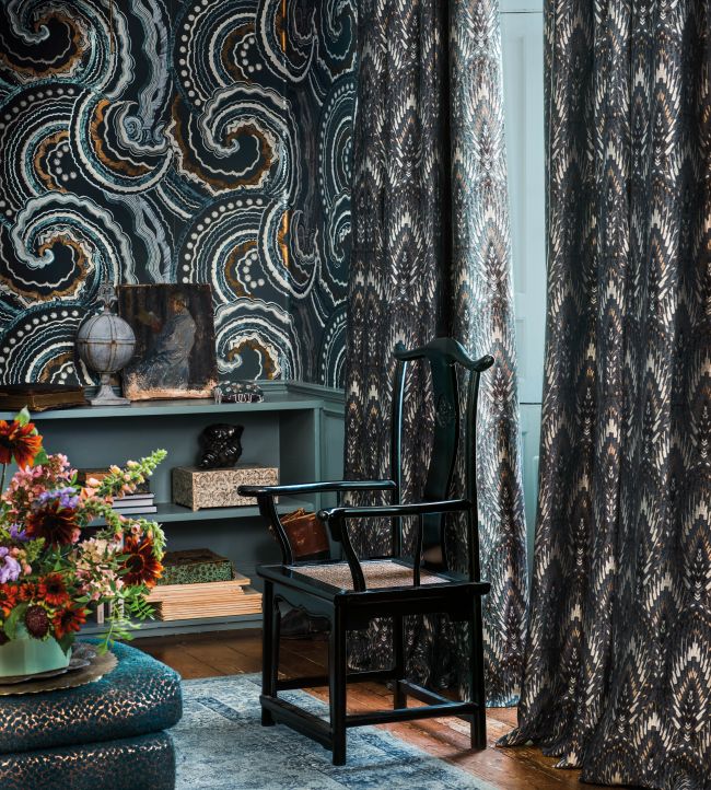 Room interior with patterned curtains and a chair.