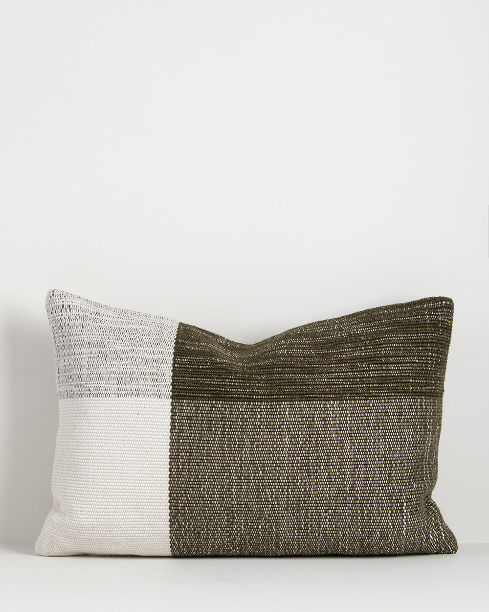 Two-tone pillow with white and brown on a light gray background