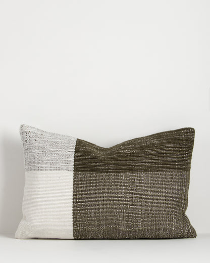 Two-tone pillow with white and brown on a light gray background