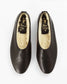 A pair of black  leather slip-on shoes with a cream-colored shearling lining, shown from a top-down view on a white background. The brand name 'Five Star Slippers' is visible on the insole.