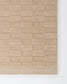 Textured beige rug with a checkered pattern on a white background