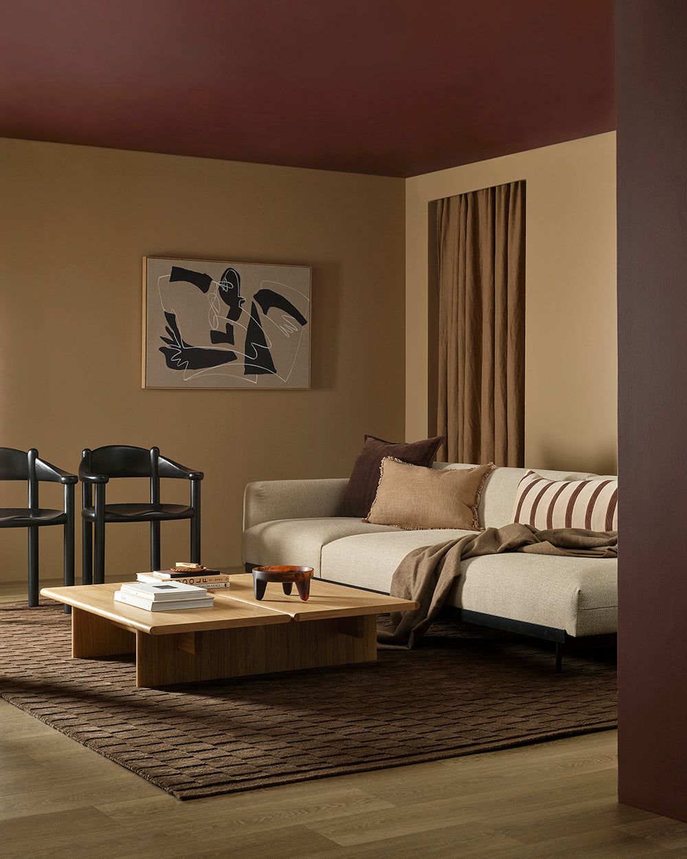 Modern living room with a sectional sofa, coffee table, and abstract art on the wall.