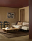 Modern living room with a sectional sofa, coffee table, and abstract art on the wall.