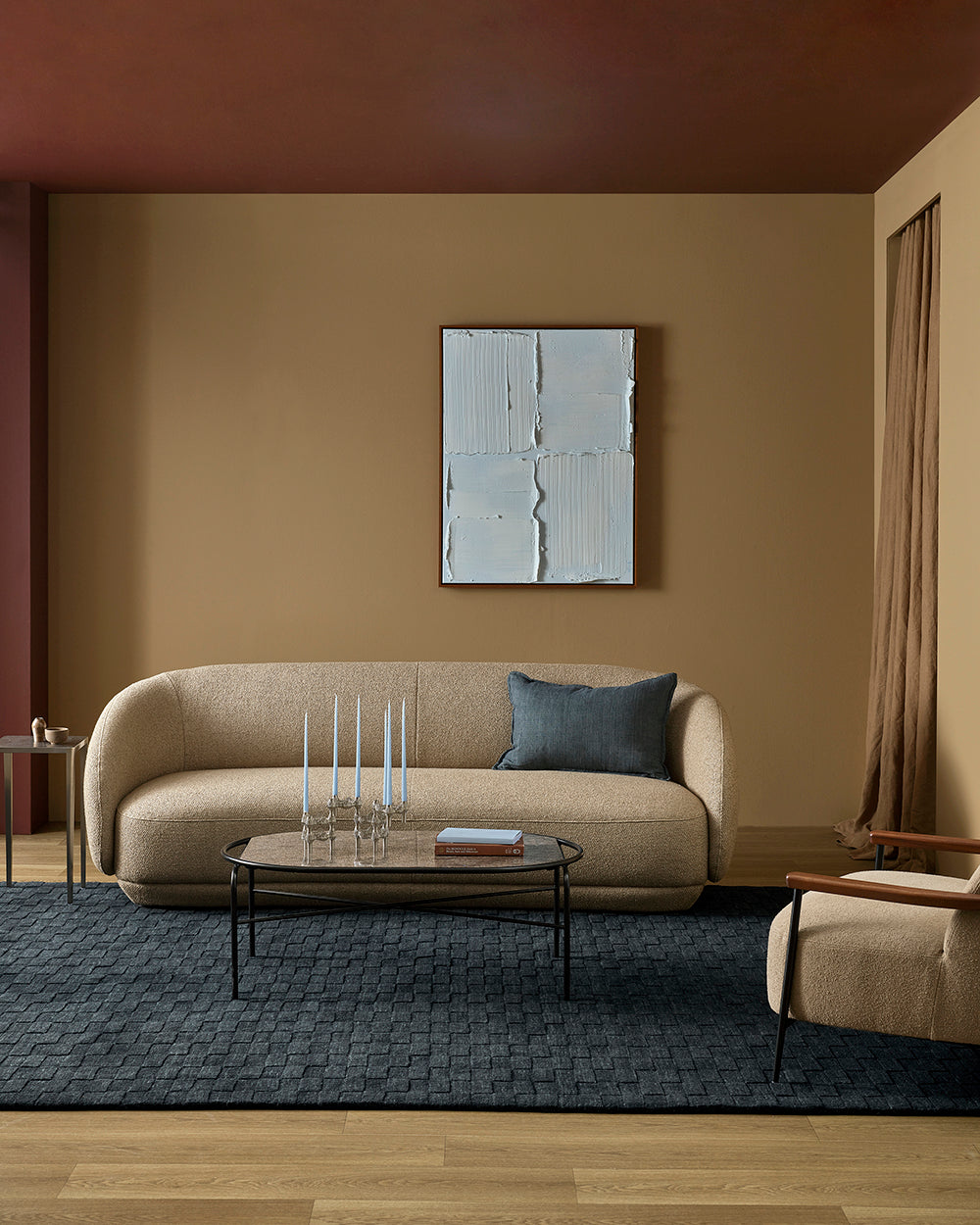 Modern living room with beige sofa, coffee table, and abstract wall art.