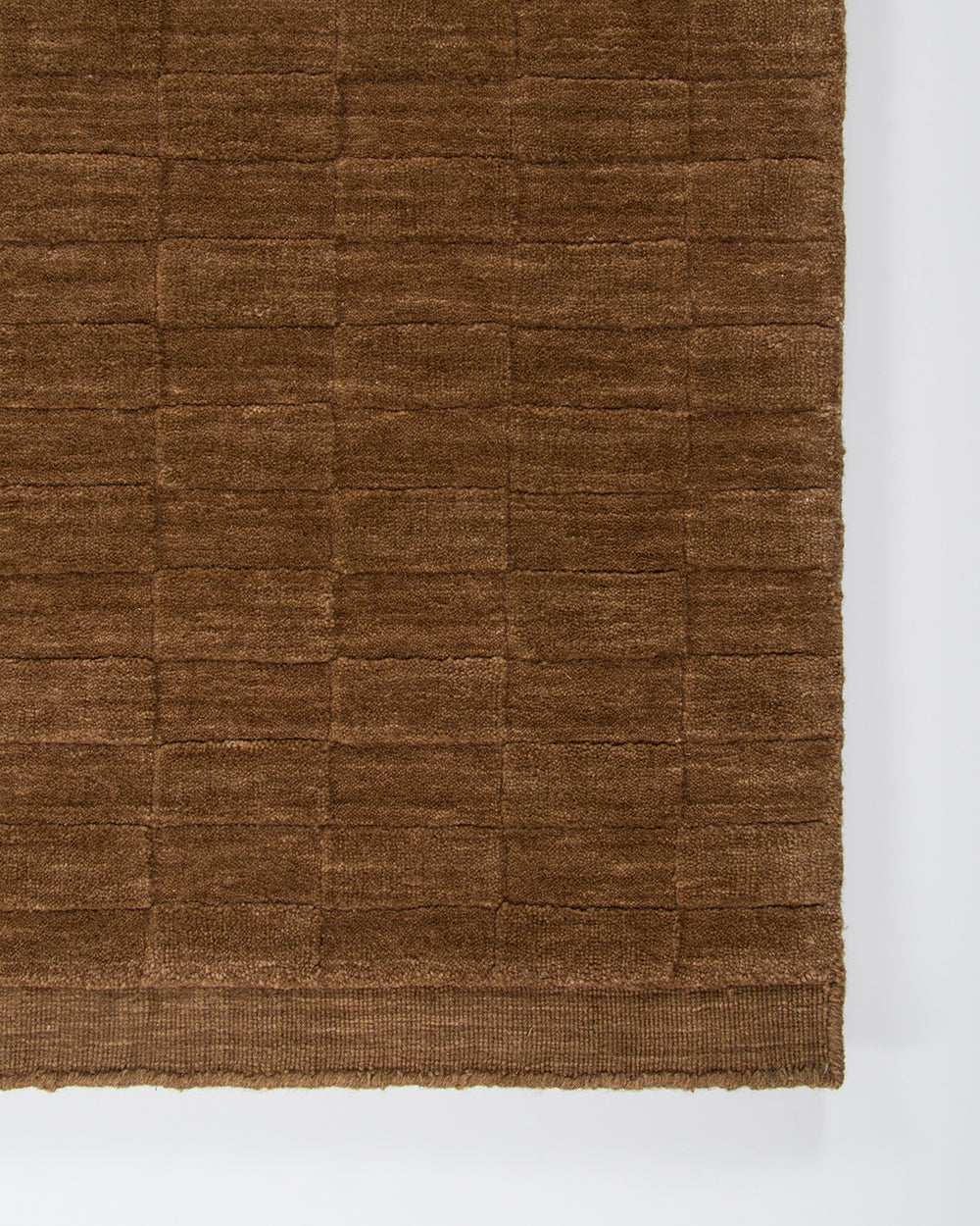 Brown textured rug on a white background