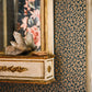 Decorative wall with leopard print wallpaper, crystal sculpture on a cabinet, and floral mirror reflection.