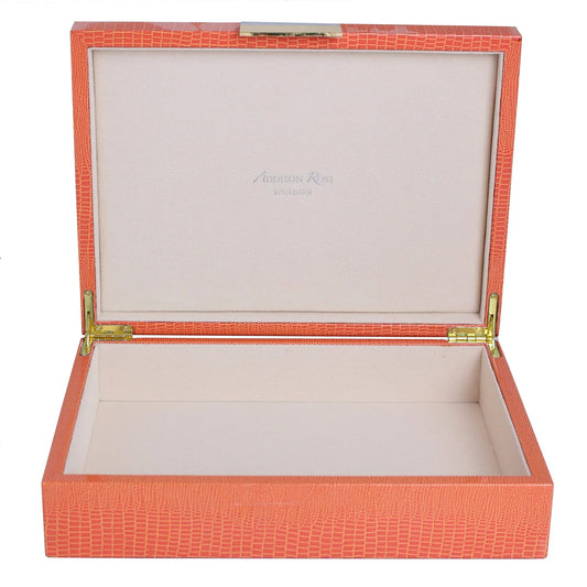 Open red jewelry box with gold hinges on a white background