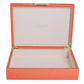 Open red jewelry box with gold hinges on a white background