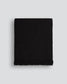 Black woven blanket on a light gray background
